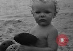 Image of boy on sandy beach United States USA, 1936, second 48 stock footage video 65675047809