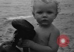 Image of boy on sandy beach United States USA, 1936, second 49 stock footage video 65675047809