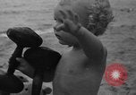 Image of boy on sandy beach United States USA, 1936, second 50 stock footage video 65675047809