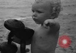 Image of boy on sandy beach United States USA, 1936, second 51 stock footage video 65675047809