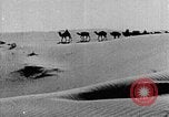 Image of caravan caught in a sand storm in desert of Saudi Arabia Saudi Arabia, 1936, second 30 stock footage video 65675050625