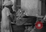 Image of shelling and drying of coconut Caracas Venezuela, 1940, second 3 stock footage video 65675050637