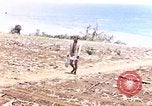 Image of American soldiers search a Japanese youth in uniform Saipan Northern Mariana Islands, 1944, second 1 stock footage video 65675050873