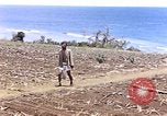 Image of American soldiers search a Japanese youth in uniform Saipan Northern Mariana Islands, 1944, second 3 stock footage video 65675050873
