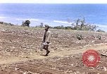 Image of American soldiers search a Japanese youth in uniform Saipan Northern Mariana Islands, 1944, second 4 stock footage video 65675050873