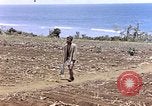 Image of American soldiers search a Japanese youth in uniform Saipan Northern Mariana Islands, 1944, second 5 stock footage video 65675050873
