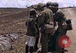 Image of American soldiers search a Japanese youth in uniform Saipan Northern Mariana Islands, 1944, second 11 stock footage video 65675050873
