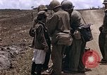 Image of American soldiers search a Japanese youth in uniform Saipan Northern Mariana Islands, 1944, second 12 stock footage video 65675050873