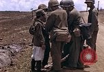 Image of American soldiers search a Japanese youth in uniform Saipan Northern Mariana Islands, 1944, second 14 stock footage video 65675050873