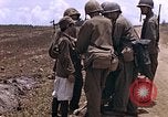 Image of American soldiers search a Japanese youth in uniform Saipan Northern Mariana Islands, 1944, second 15 stock footage video 65675050873