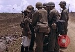 Image of American soldiers search a Japanese youth in uniform Saipan Northern Mariana Islands, 1944, second 16 stock footage video 65675050873