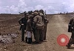 Image of American soldiers search a Japanese youth in uniform Saipan Northern Mariana Islands, 1944, second 18 stock footage video 65675050873