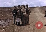 Image of American soldiers search a Japanese youth in uniform Saipan Northern Mariana Islands, 1944, second 19 stock footage video 65675050873