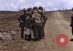 Image of American soldiers search a Japanese youth in uniform Saipan Northern Mariana Islands, 1944, second 20 stock footage video 65675050873