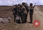 Image of American soldiers search a Japanese youth in uniform Saipan Northern Mariana Islands, 1944, second 21 stock footage video 65675050873