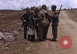 Image of American soldiers search a Japanese youth in uniform Saipan Northern Mariana Islands, 1944, second 22 stock footage video 65675050873