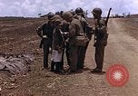 Image of American soldiers search a Japanese youth in uniform Saipan Northern Mariana Islands, 1944, second 23 stock footage video 65675050873
