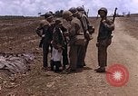 Image of American soldiers search a Japanese youth in uniform Saipan Northern Mariana Islands, 1944, second 24 stock footage video 65675050873