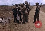 Image of American soldiers search a Japanese youth in uniform Saipan Northern Mariana Islands, 1944, second 25 stock footage video 65675050873