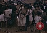 Image of American soldiers search a Japanese youth in uniform Saipan Northern Mariana Islands, 1944, second 26 stock footage video 65675050873