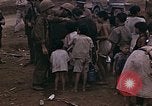 Image of American soldiers search a Japanese youth in uniform Saipan Northern Mariana Islands, 1944, second 30 stock footage video 65675050873