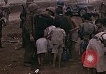 Image of American soldiers search a Japanese youth in uniform Saipan Northern Mariana Islands, 1944, second 31 stock footage video 65675050873