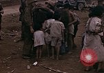 Image of American soldiers search a Japanese youth in uniform Saipan Northern Mariana Islands, 1944, second 32 stock footage video 65675050873