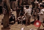 Image of American soldiers search a Japanese youth in uniform Saipan Northern Mariana Islands, 1944, second 34 stock footage video 65675050873