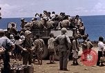 Image of American soldiers search a Japanese youth in uniform Saipan Northern Mariana Islands, 1944, second 37 stock footage video 65675050873