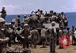Image of American soldiers search a Japanese youth in uniform Saipan Northern Mariana Islands, 1944, second 40 stock footage video 65675050873