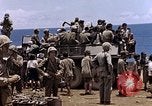 Image of American soldiers search a Japanese youth in uniform Saipan Northern Mariana Islands, 1944, second 41 stock footage video 65675050873