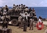 Image of American soldiers search a Japanese youth in uniform Saipan Northern Mariana Islands, 1944, second 50 stock footage video 65675050873