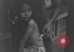Image of Okinawa civilian wounded receive treatment  Okinawa Ryukyu Islands, 1945, second 34 stock footage video 65675051481