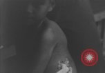 Image of Okinawa civilian wounded receive treatment  Okinawa Ryukyu Islands, 1945, second 42 stock footage video 65675051481