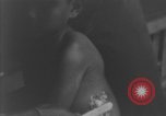 Image of Okinawa civilian wounded receive treatment  Okinawa Ryukyu Islands, 1945, second 44 stock footage video 65675051481