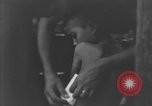 Image of Okinawa civilian wounded receive treatment  Okinawa Ryukyu Islands, 1945, second 49 stock footage video 65675051481