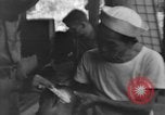 Image of Okinawa civilian wounded receive treatment  Okinawa Ryukyu Islands, 1945, second 62 stock footage video 65675051481
