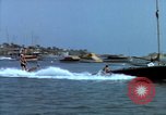 Image of motorboat pulling man and woman balanced on aquaplane United States USA, 1939, second 5 stock footage video 65675051556
