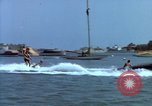 Image of motorboat pulling man and woman balanced on aquaplane United States USA, 1939, second 6 stock footage video 65675051556