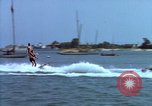 Image of motorboat pulling man and woman balanced on aquaplane United States USA, 1939, second 7 stock footage video 65675051556