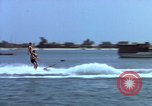 Image of motorboat pulling man and woman balanced on aquaplane United States USA, 1939, second 8 stock footage video 65675051556
