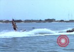 Image of motorboat pulling man and woman balanced on aquaplane United States USA, 1939, second 10 stock footage video 65675051556