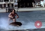 Image of motorboat pulling man and woman balanced on aquaplane United States USA, 1939, second 11 stock footage video 65675051556