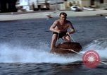 Image of motorboat pulling man and woman balanced on aquaplane United States USA, 1939, second 13 stock footage video 65675051556