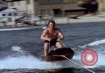 Image of motorboat pulling man and woman balanced on aquaplane United States USA, 1939, second 14 stock footage video 65675051556