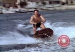 Image of motorboat pulling man and woman balanced on aquaplane United States USA, 1939, second 15 stock footage video 65675051556