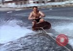 Image of motorboat pulling man and woman balanced on aquaplane United States USA, 1939, second 16 stock footage video 65675051556