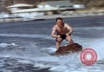 Image of motorboat pulling man and woman balanced on aquaplane United States USA, 1939, second 17 stock footage video 65675051556