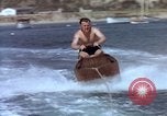 Image of motorboat pulling man and woman balanced on aquaplane United States USA, 1939, second 19 stock footage video 65675051556