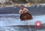 Image of motorboat pulling man and woman balanced on aquaplane United States USA, 1939, second 20 stock footage video 65675051556